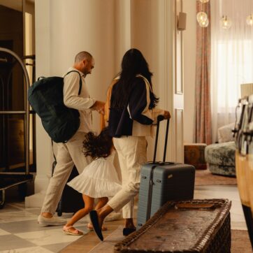 Mom, dad and child walking through hotel lobby