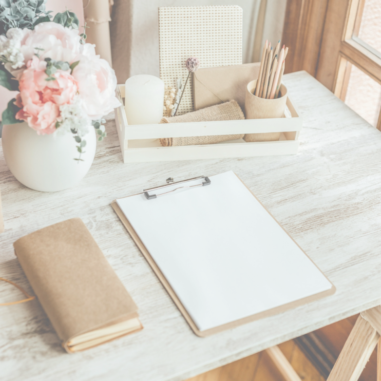notepad and flowers on a table